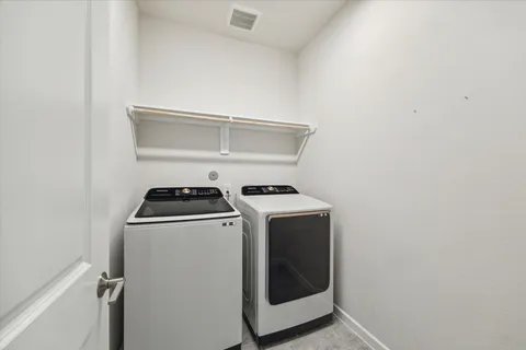 an empty room with windows and entrance