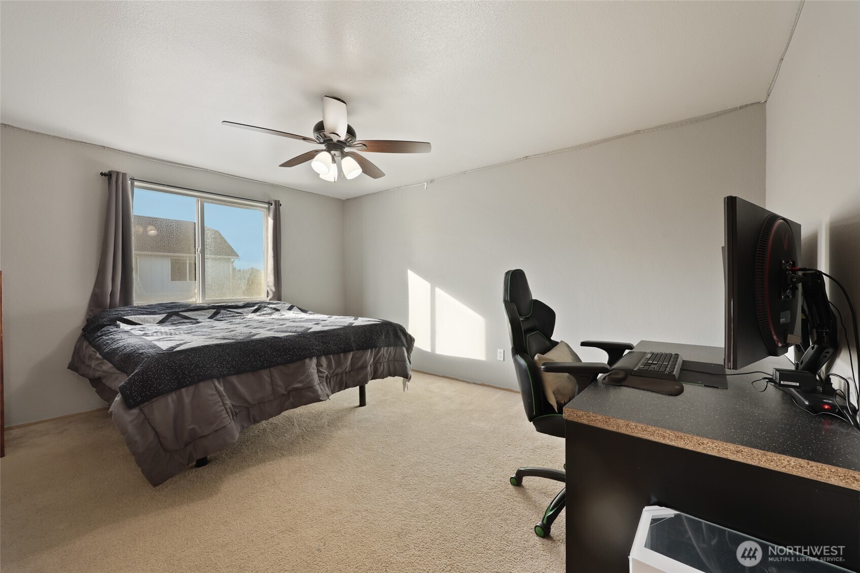 9826 Greenleaf Loop Southeast Yelm, WA 98597 - Photo 18 of 36 a bedroom with a bed desk and a window