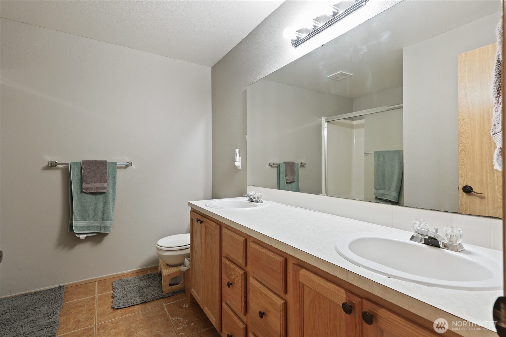 9826 Greenleaf Loop Southeast Yelm, WA 98597 - Photo 20 of 36 a bathroom with a granite countertop sink mirror and toilet