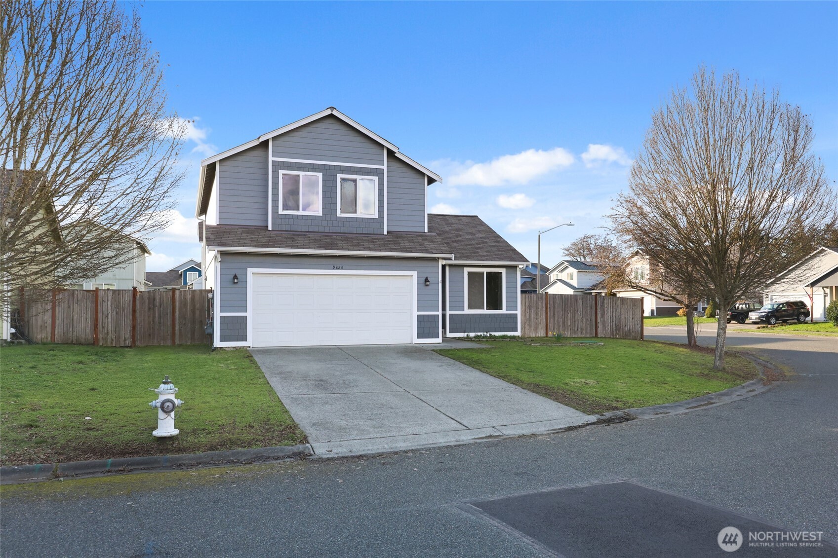 9826 Greenleaf Loop Southeast Yelm, WA 98597 - Photo 2 of 36 a front view of a house with a yard and garage