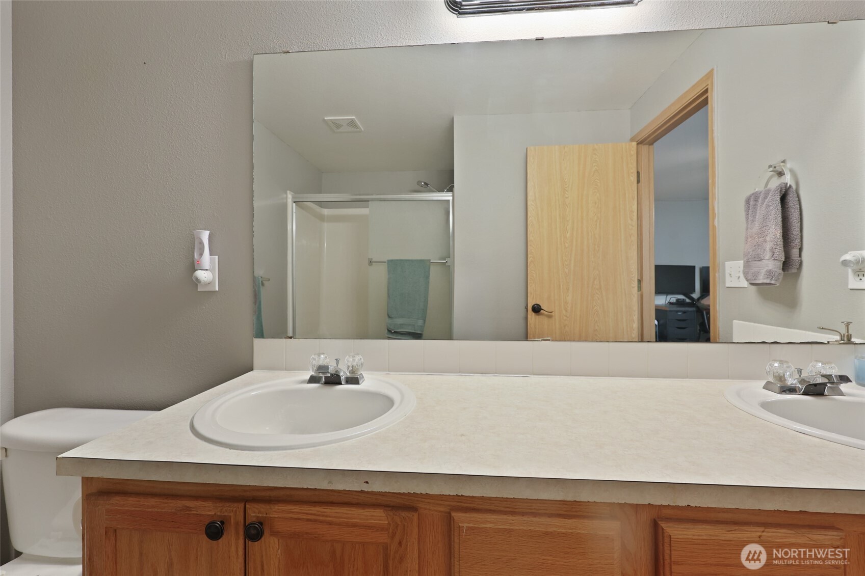 9826 Greenleaf Loop Southeast Yelm, WA 98597 - Photo 21 of 36 a bathroom with a sink and a mirror
