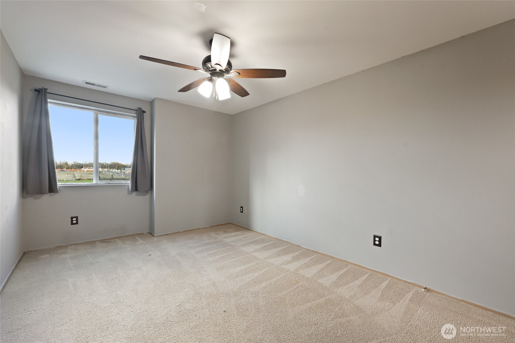 9826 Greenleaf Loop Southeast Yelm, WA 98597 - Photo 23 of 36 a view of an empty room with a window