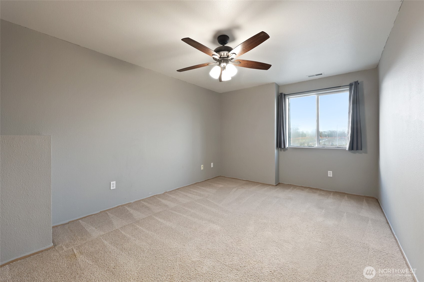 9826 Greenleaf Loop Southeast Yelm, WA 98597 - Photo 26 of 36 a view of an empty room with a window