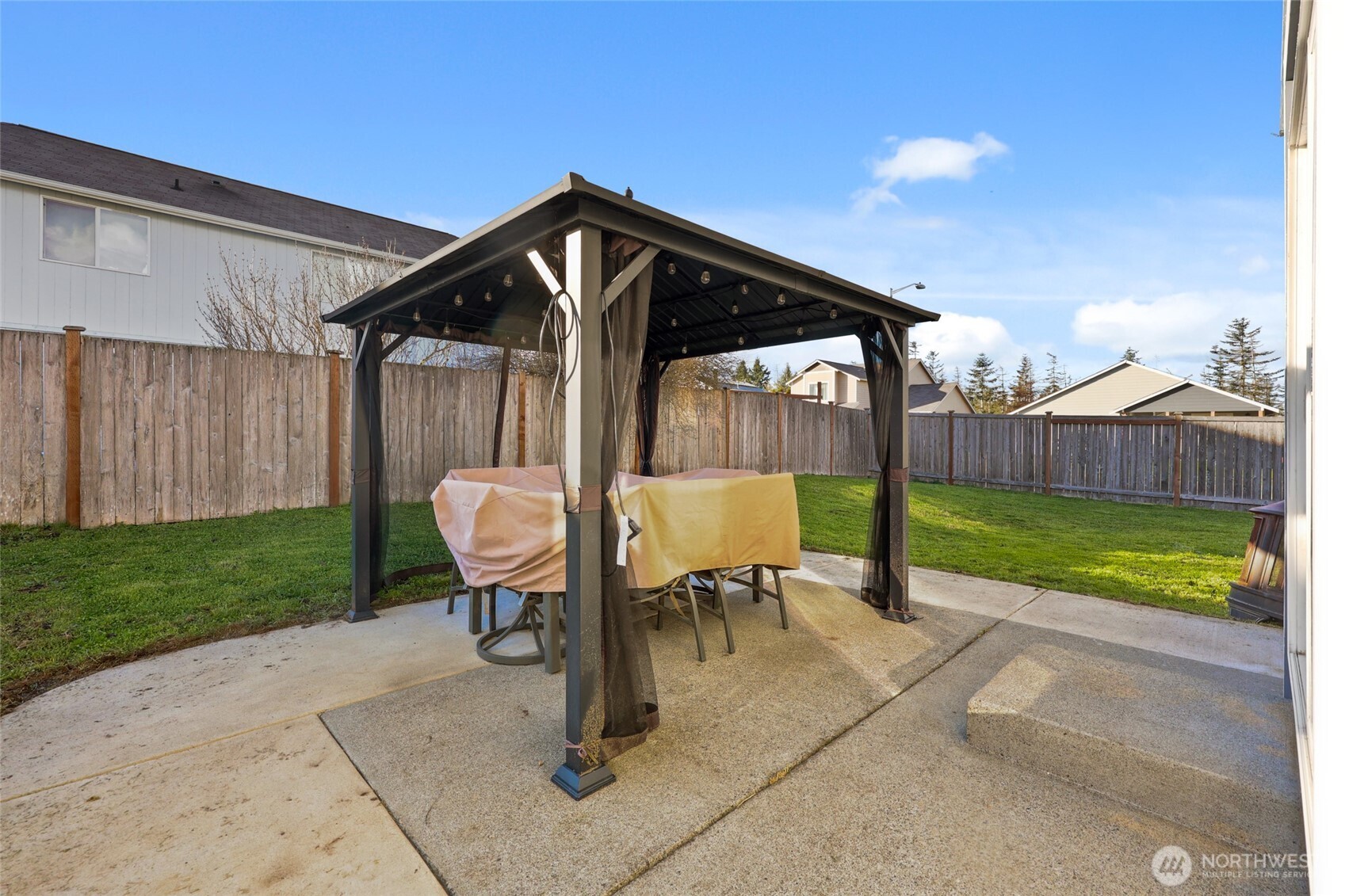 9826 Greenleaf Loop Southeast Yelm, WA 98597 - Photo 28 of 36 a view of a house with backyard and a patio