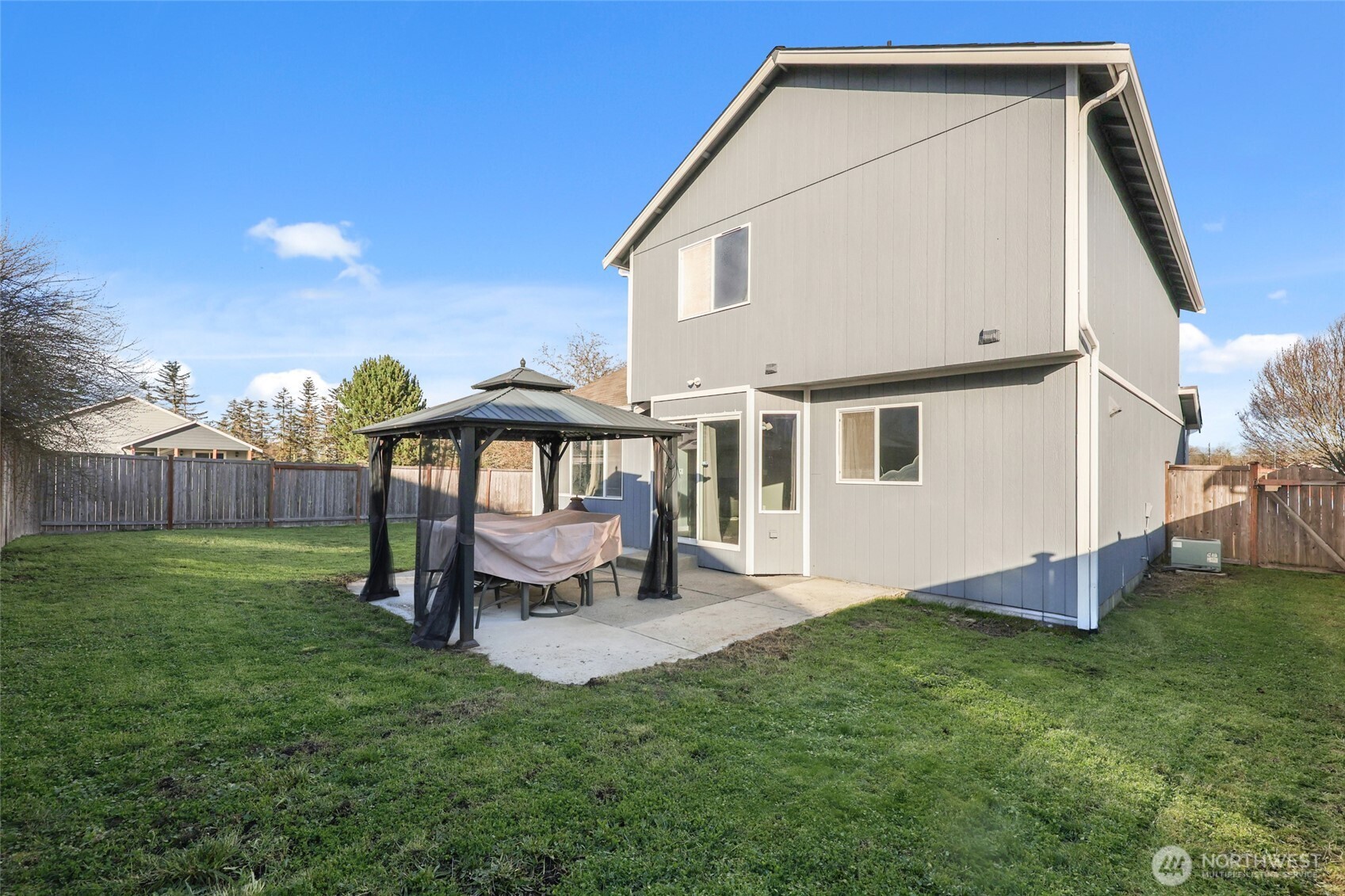 9826 Greenleaf Loop Southeast Yelm, WA 98597 - Photo 29 of 36 a view of a house with a yard and sitting area
