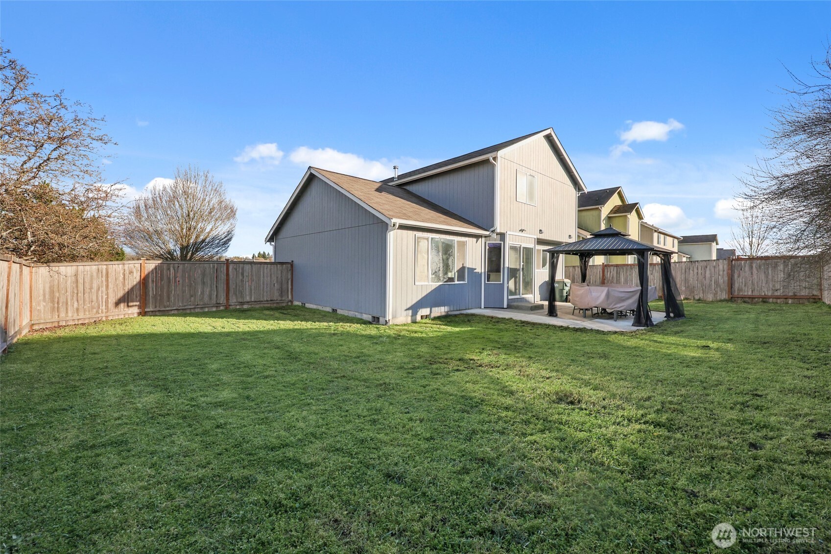 9826 Greenleaf Loop Southeast Yelm, WA 98597 - Photo 30 of 36 a view of a house with a yard and sitting area