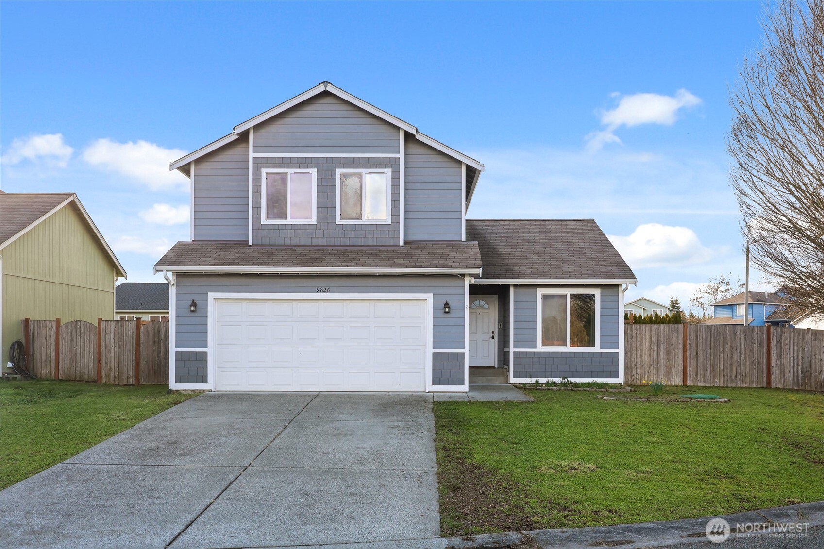 9826 Greenleaf Loop Southeast Yelm, WA 98597 - Photo 35 of 36 a front view of a house with a yard and garage