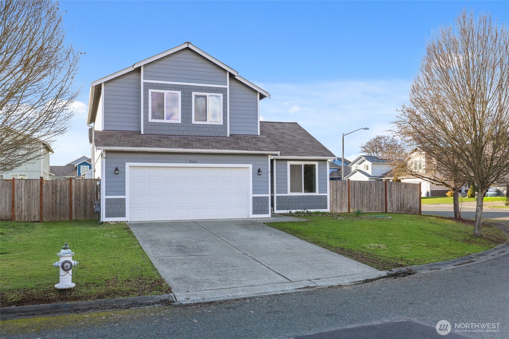 9826 Greenleaf Loop Southeast Yelm, WA 98597 - Photo 36 of 36 a front view of a house with a yard and garage
