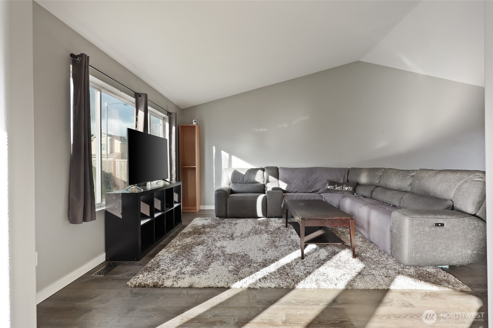 9826 Greenleaf Loop Southeast Yelm, WA 98597 - Photo 8 of 36 a living room with furniture and a flat screen tv