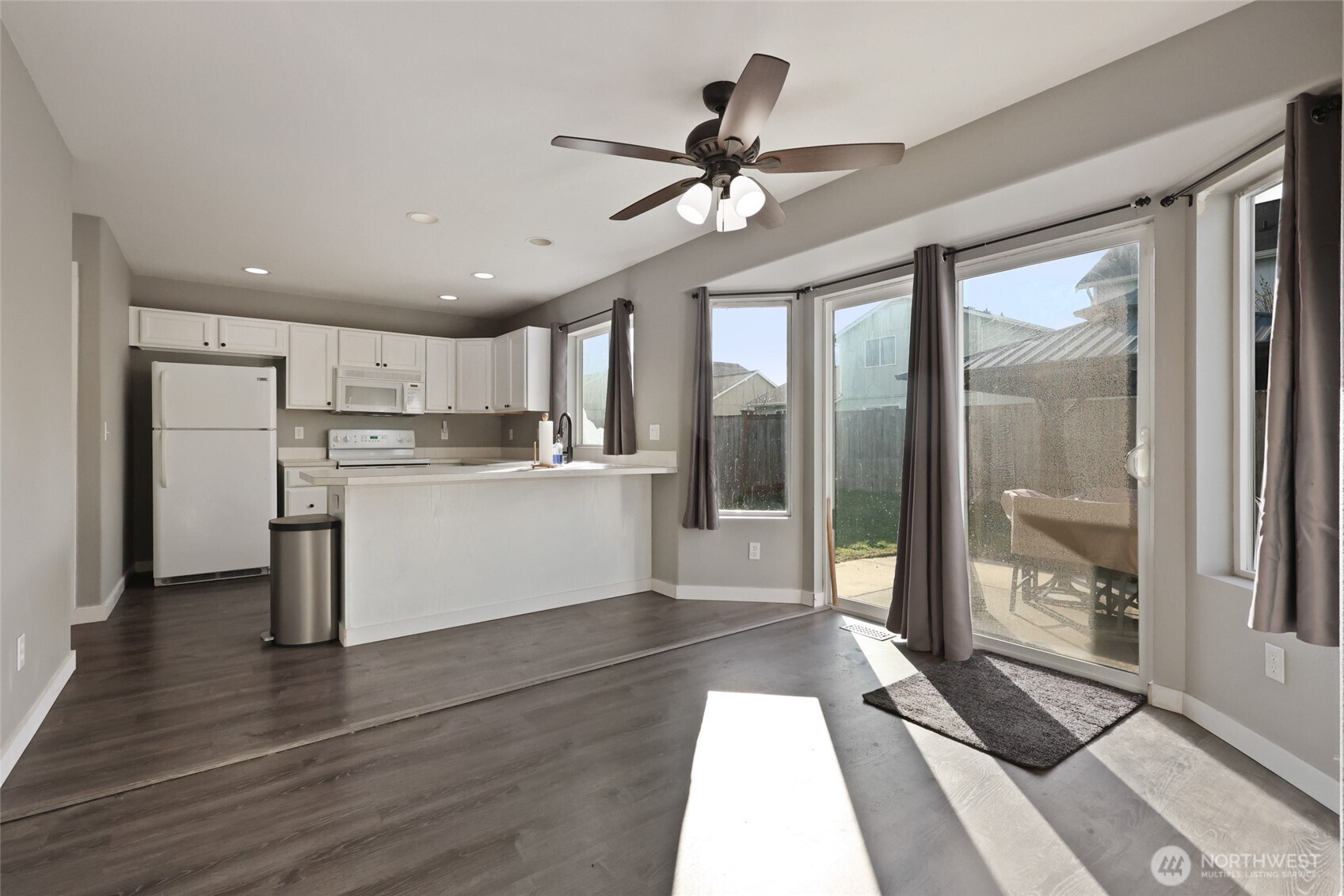 9826 Greenleaf Loop Southeast Yelm, WA 98597 - Photo 10 of 36 a view of a kitchen with wooden floor and a window