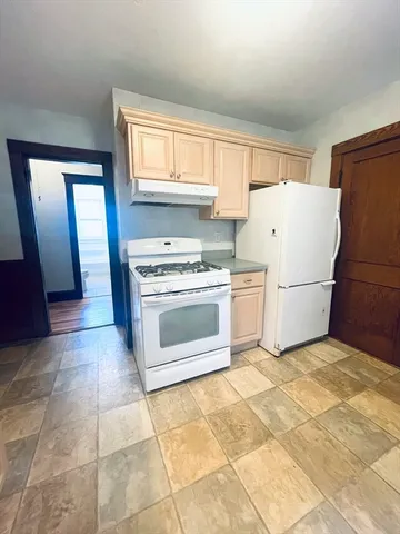 a kitchen with a stove a refrigerator and a cabinets