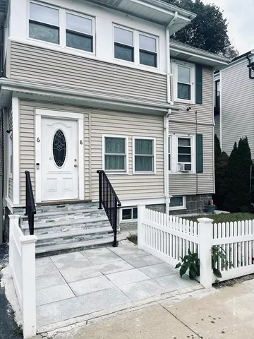 a front view of a house with stairs