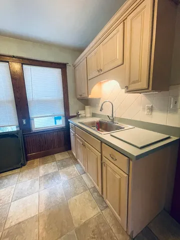 a kitchen with a sink cabinets and window
