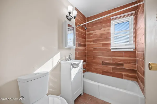 a bathroom with a bathtub and a toilet