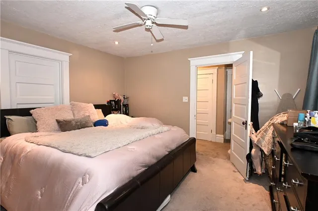 a bedroom with bed and window