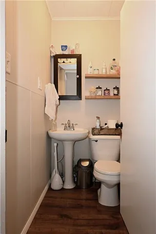 a bathroom with a toilet and a mirror