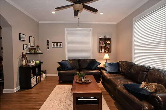a living room with furniture and wooden floor