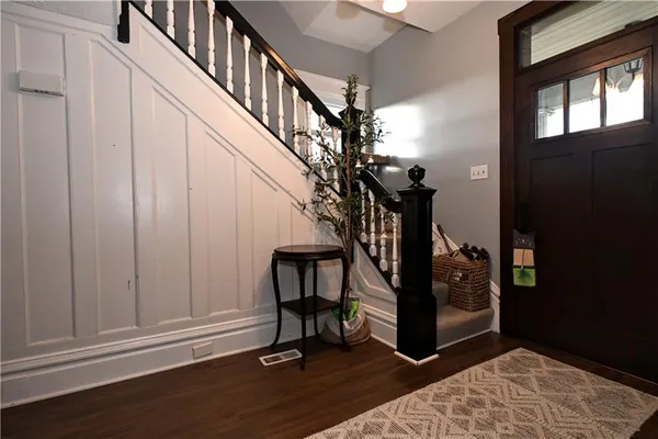 a view of entryway with wooden floor and door