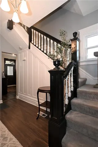 a view of entryway livingroom and hall with wooden floor