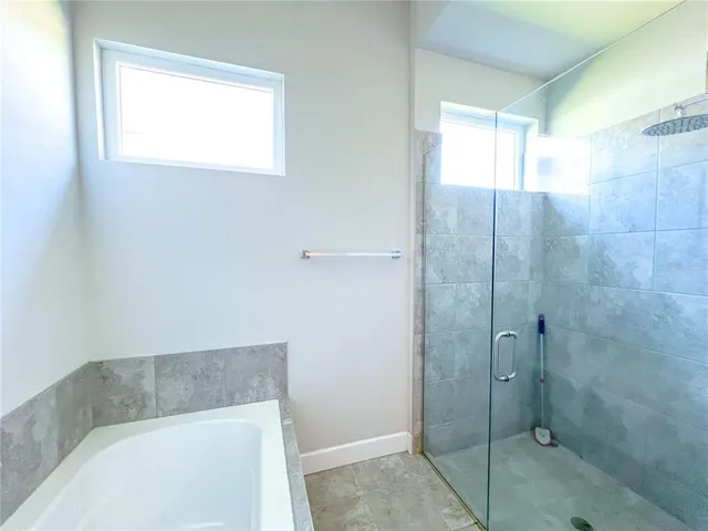 a bathroom with a bathtub and shower