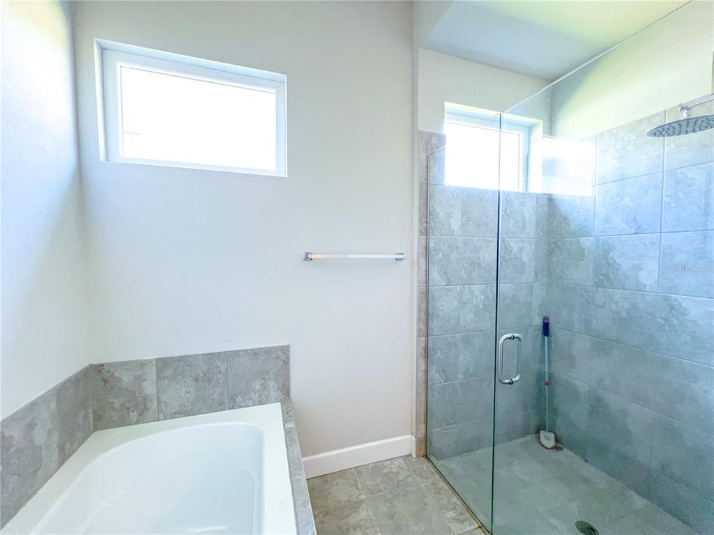 9340 Southwest 67th Lane Gainesville, FL 32608 - Photo 14 of 16 a bathroom with a bathtub and shower