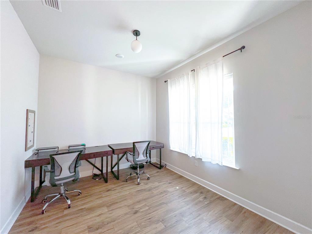 9340 Southwest 67th Lane Gainesville, FL 32608 - Photo 2 of 16 a view of a workspace with furniture and a window