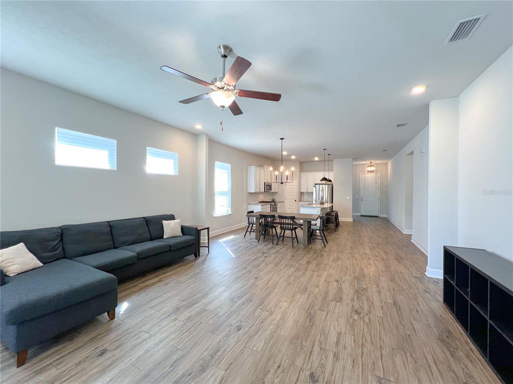 9340 Southwest 67th Lane Gainesville, FL 32608 - Photo 7 of 16 a living room with furniture and wooden floor
