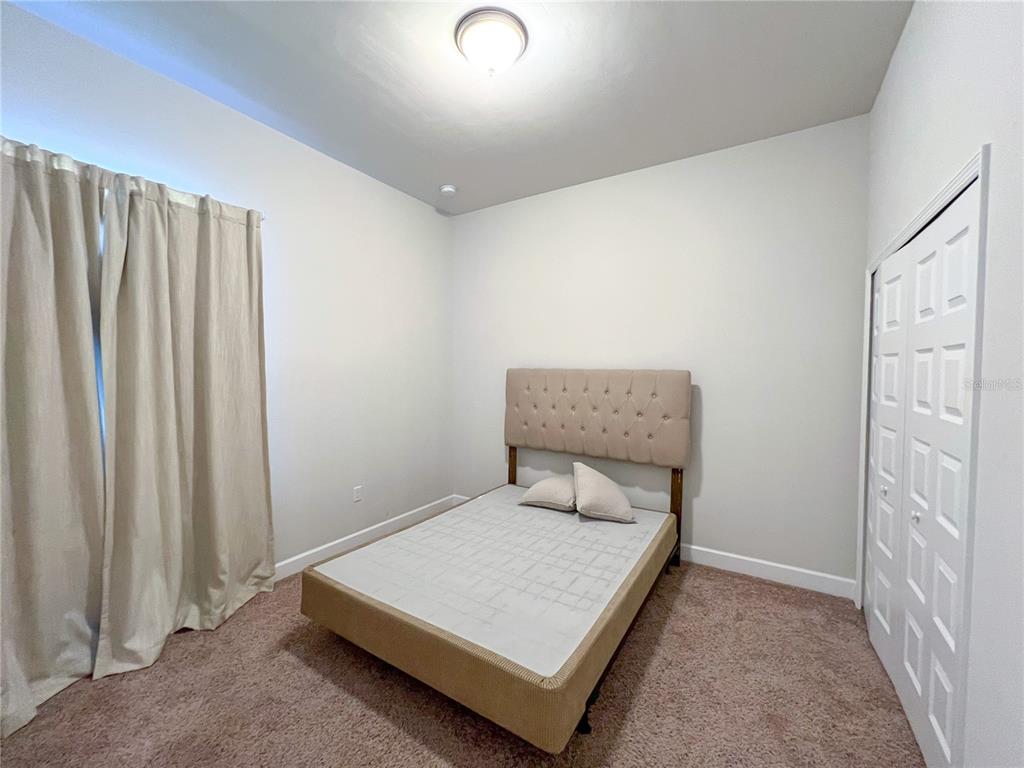 9340 Southwest 67th Lane Gainesville, FL 32608 - Photo 9 of 16 a room with a bed and a window