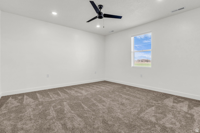 520 East 450th Street North Delta, UT 84624 - Photo 17 of 48 Spare room featuring dark carpet, recessed lighting, and ceiling fan
