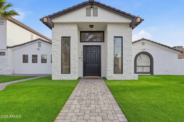 a front view of a house with garden