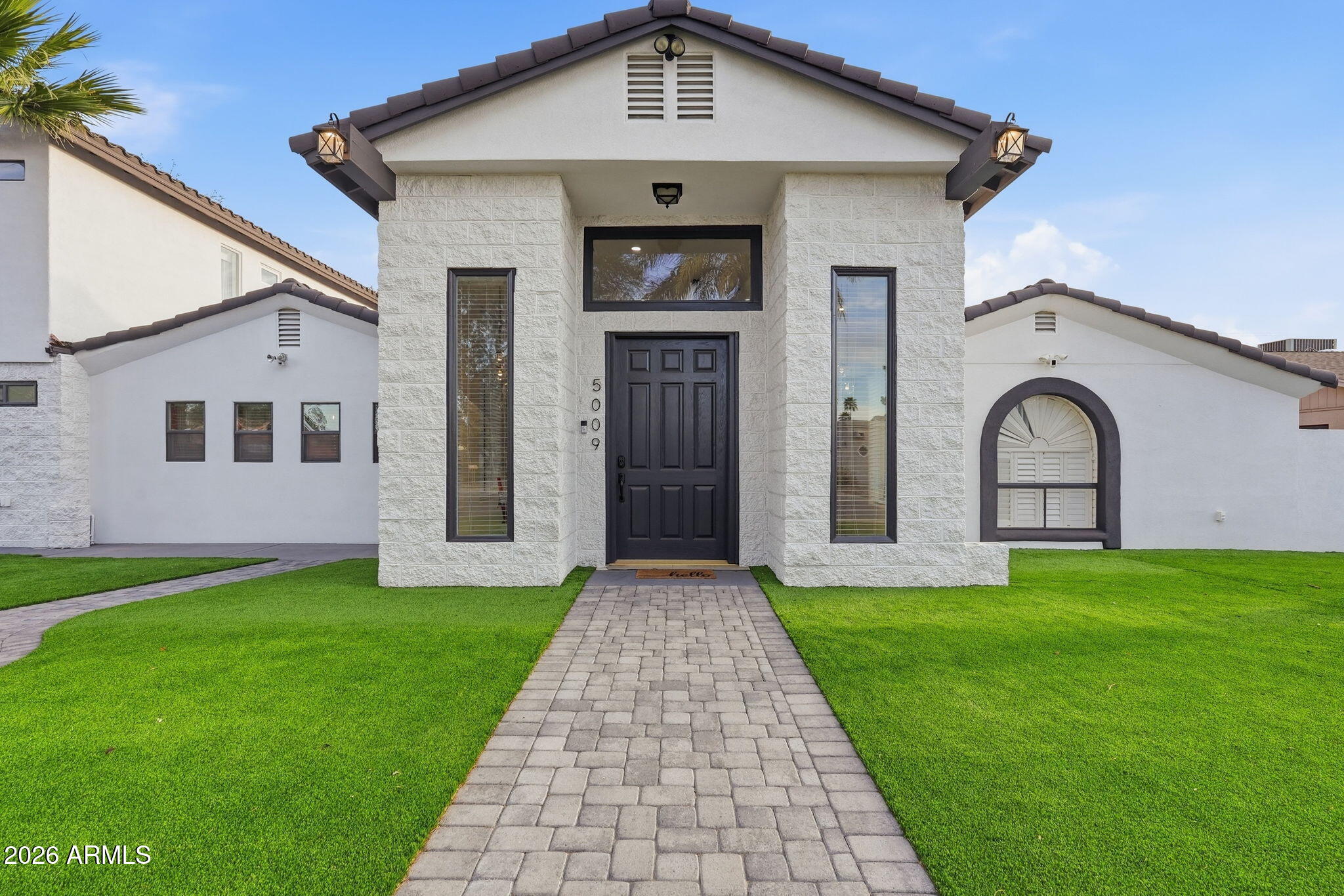 5009 East Wethersfield Road Scottsdale, AZ 85254 - Photo 1 of 30 a front view of a house with garden