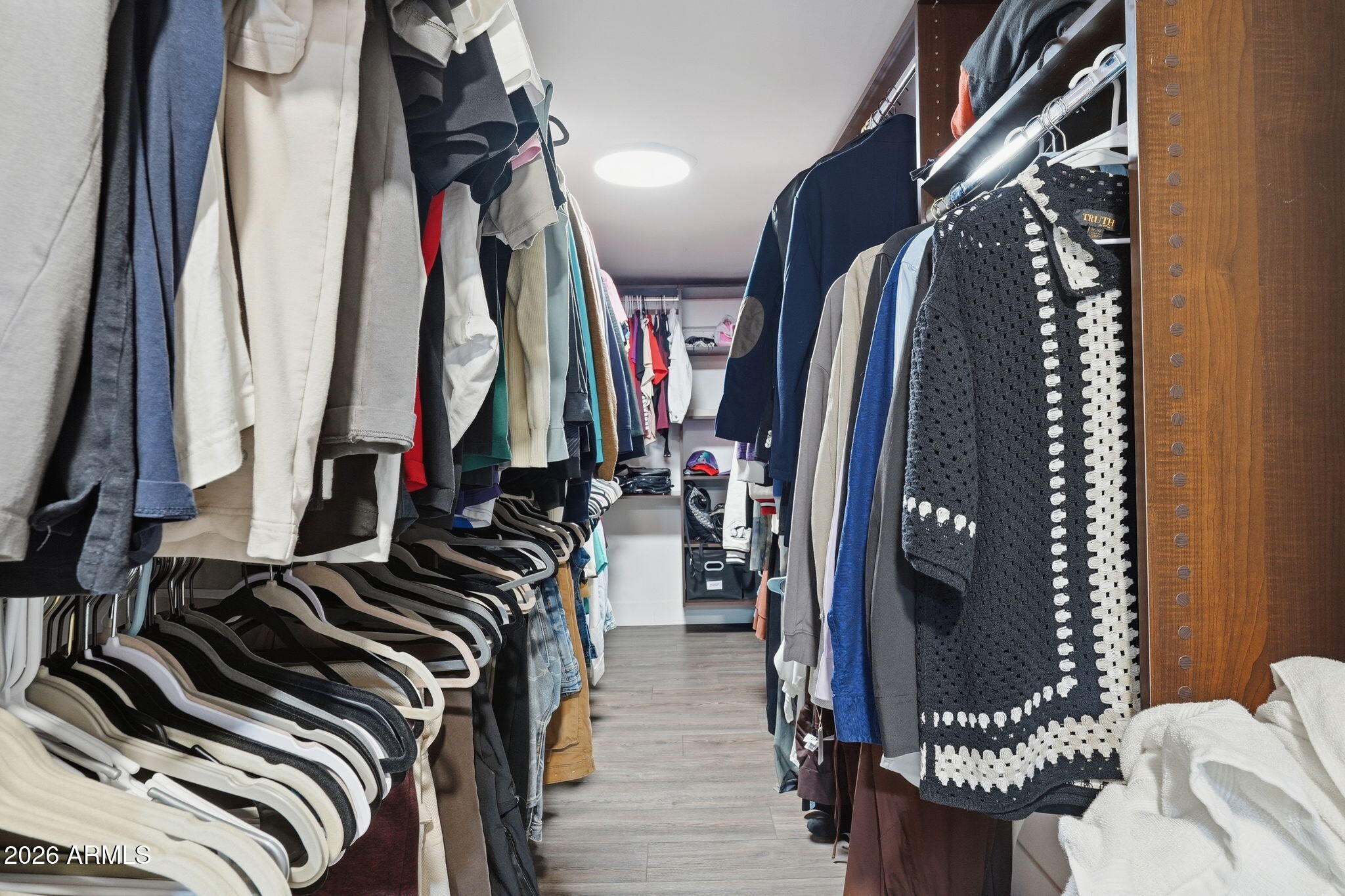 5009 East Wethersfield Road Scottsdale, AZ 85254 - Photo 17 of 30 a view of walk in closet with clothes and shoes