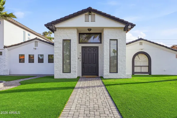 a front view of house with yard and green space
