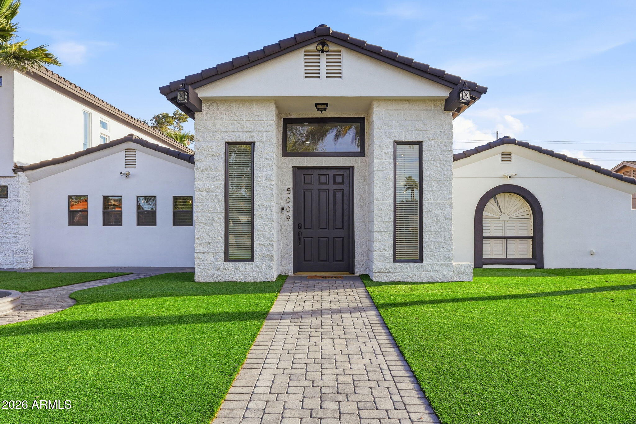 5009 East Wethersfield Road Scottsdale, AZ 85254 - Photo 2 of 30 a front view of house with yard and green space