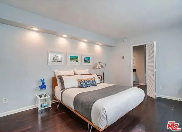 a bedroom with a bed and a potted plant