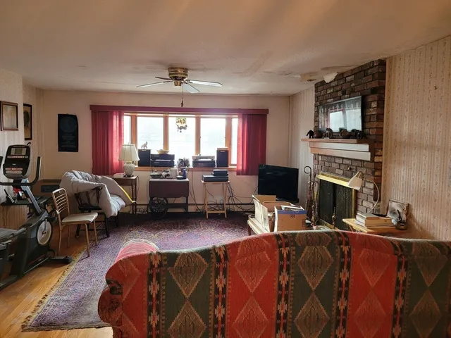 a living room with furniture fireplace and flat screen tv