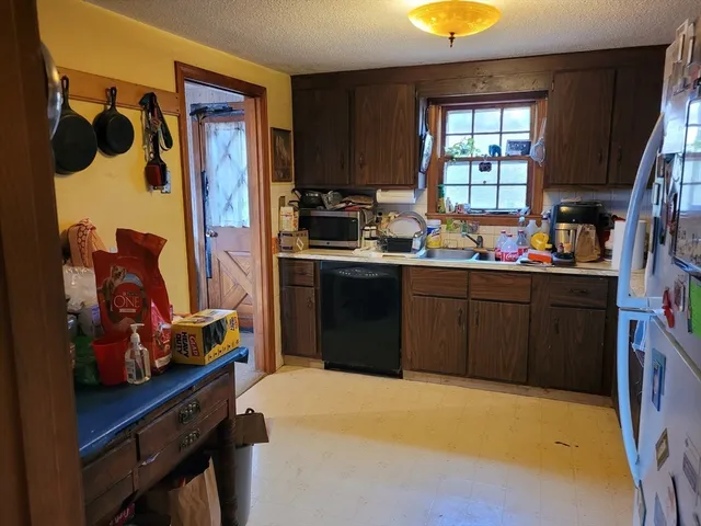 a kitchen with a sink cabinets and window