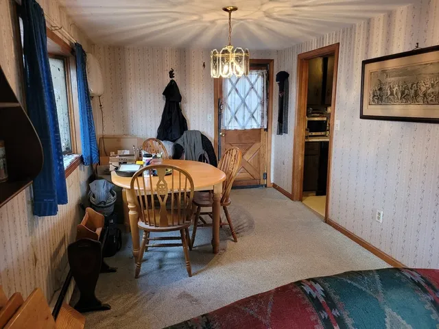 a view of a dining room with furniture and chandelier