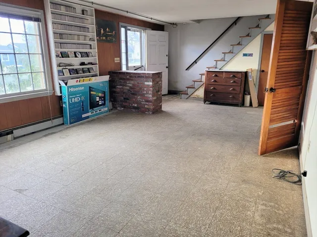 an empty room with furniture and windows