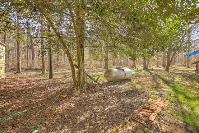 a backyard of a house with table and chairs