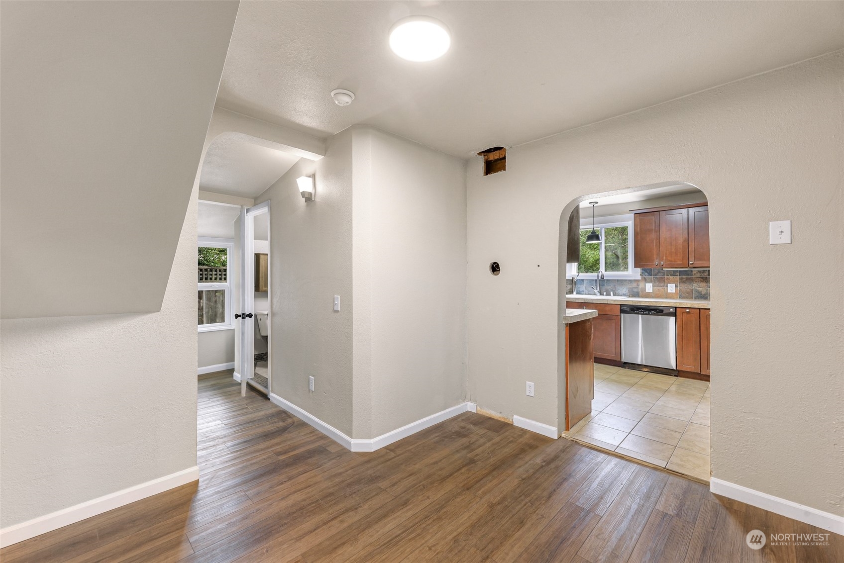 1102 Nevada Street Bellingham, WA 98229 - Photo 11 of 40 a view of a kitchen and an empty room with wooden floor