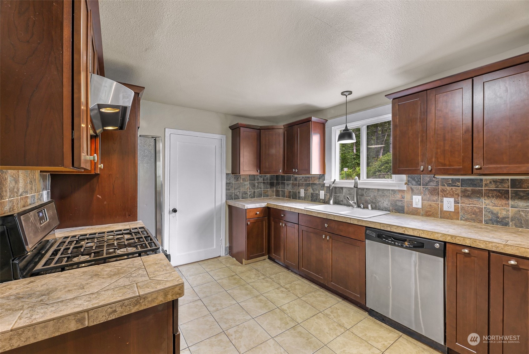 1102 Nevada Street Bellingham, WA 98229 - Photo 13 of 40 a kitchen with stainless steel appliances granite countertop a stove a sink and a refrigerator