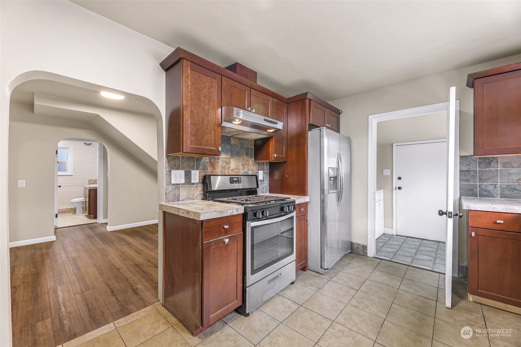 1102 Nevada Street Bellingham, WA 98229 - Photo 15 of 40 a kitchen with stainless steel appliances granite countertop a stove a refrigerator and a wooden cabinets
