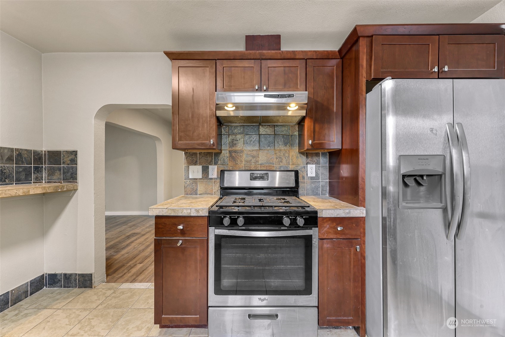 1102 Nevada Street Bellingham, WA 98229 - Photo 17 of 40 a kitchen with granite countertop a stove and a refrigerator
