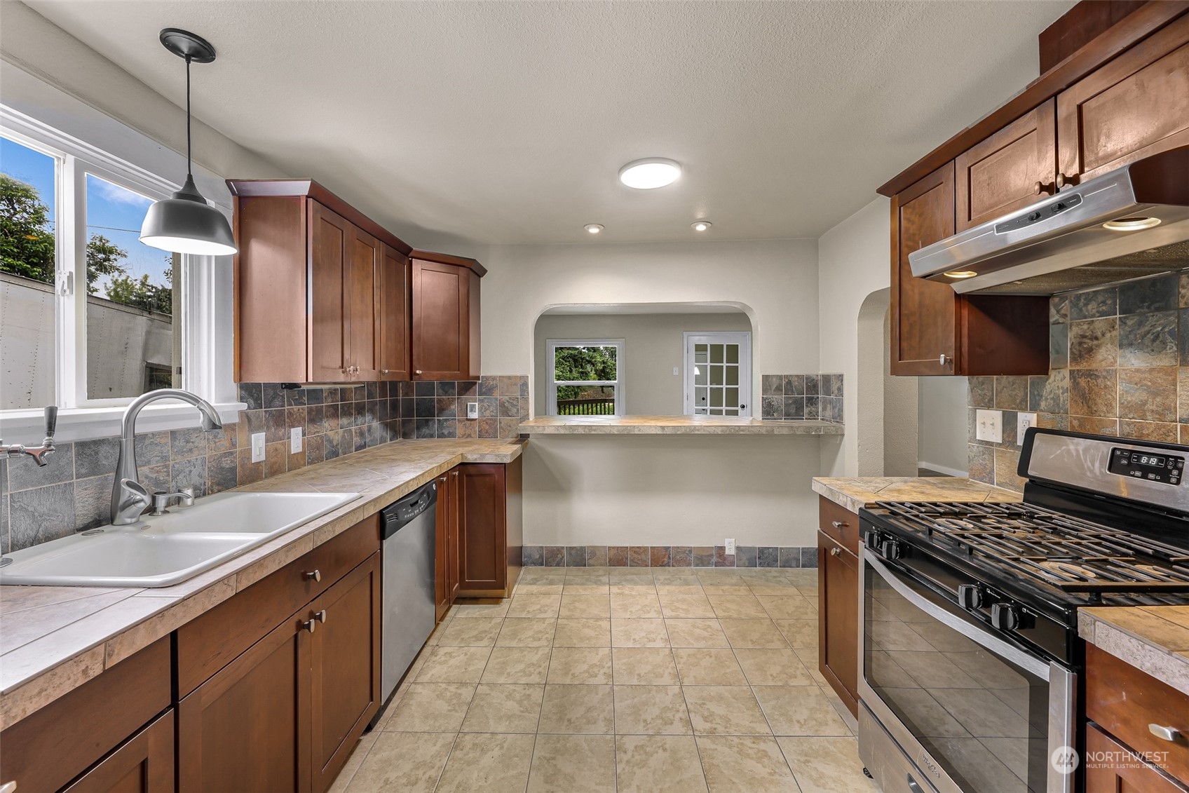1102 Nevada Street Bellingham, WA 98229 - Photo 19 of 40 a kitchen with stainless steel appliances granite countertop a sink stove and cabinets