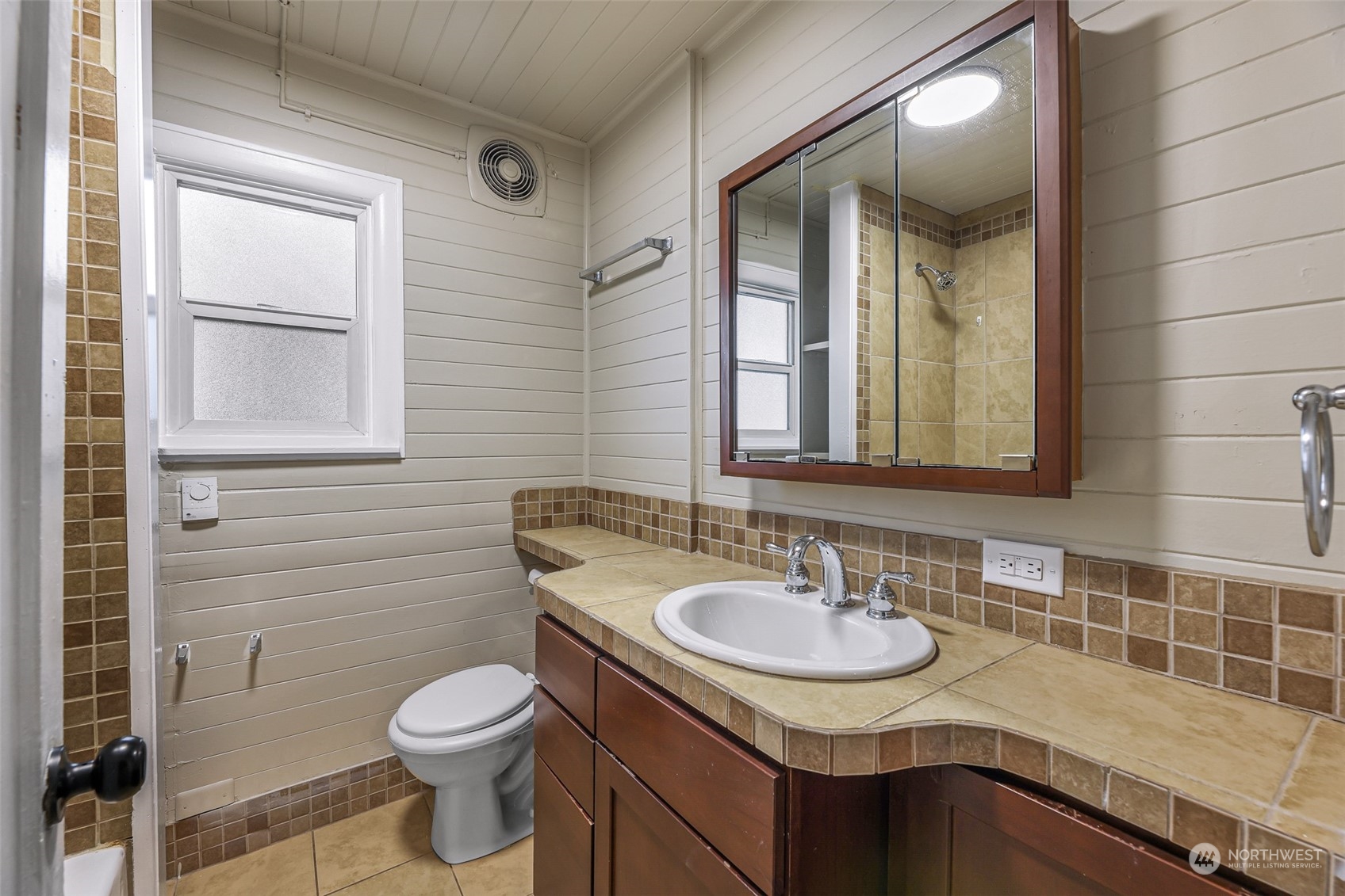 1102 Nevada Street Bellingham, WA 98229 - Photo 21 of 40 a bathroom with a granite countertop sink and a toilet