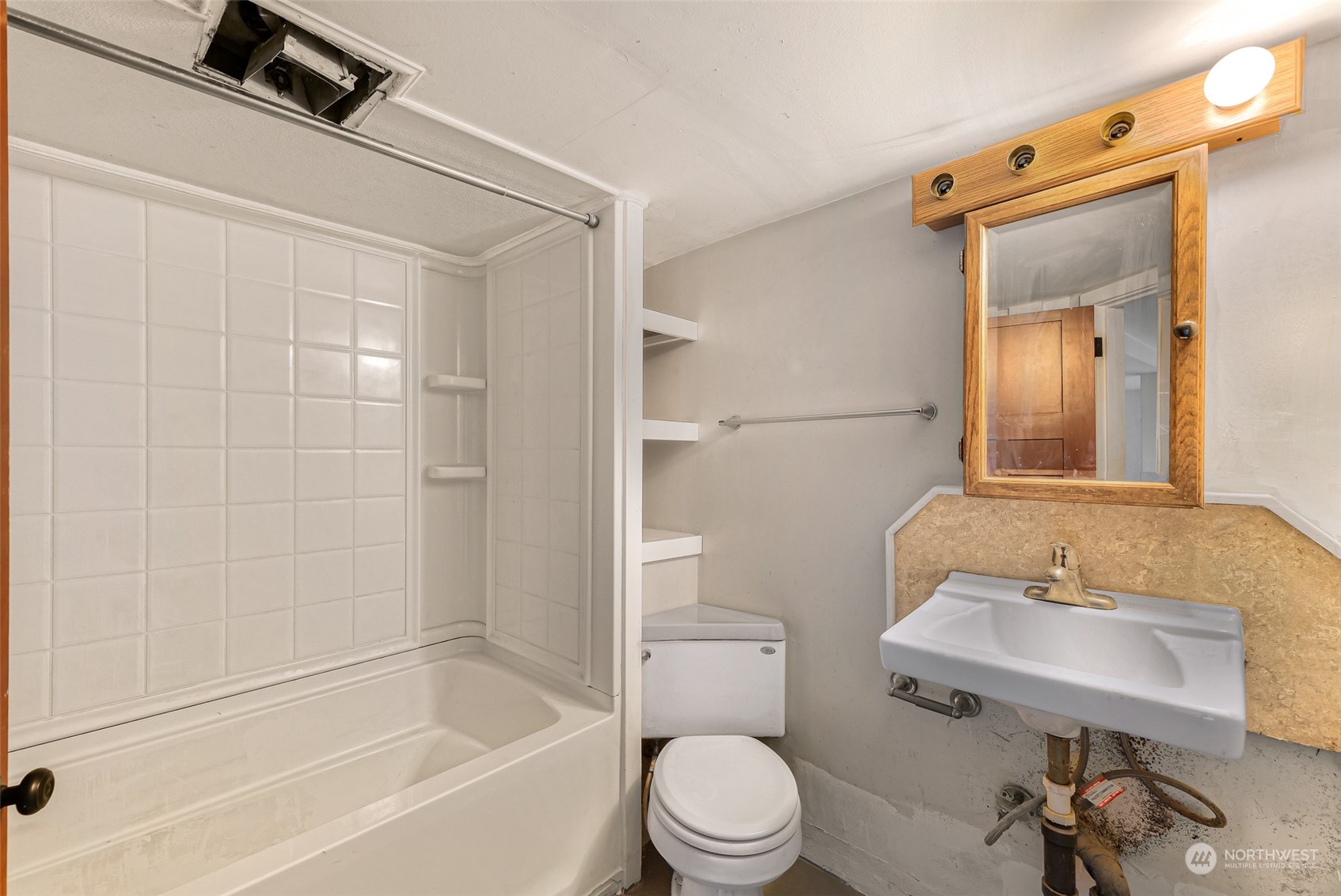 1102 Nevada Street Bellingham, WA 98229 - Photo 34 of 40 a bathroom with a sink toilet a mirror and shower