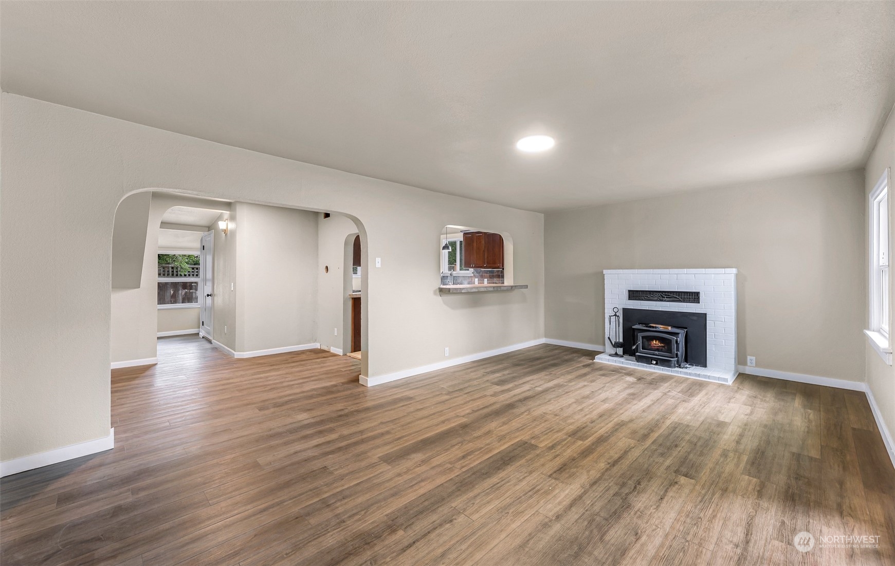 1102 Nevada Street Bellingham, WA 98229 - Photo 4 of 40 a view of an empty room with wooden floor fireplace and a window