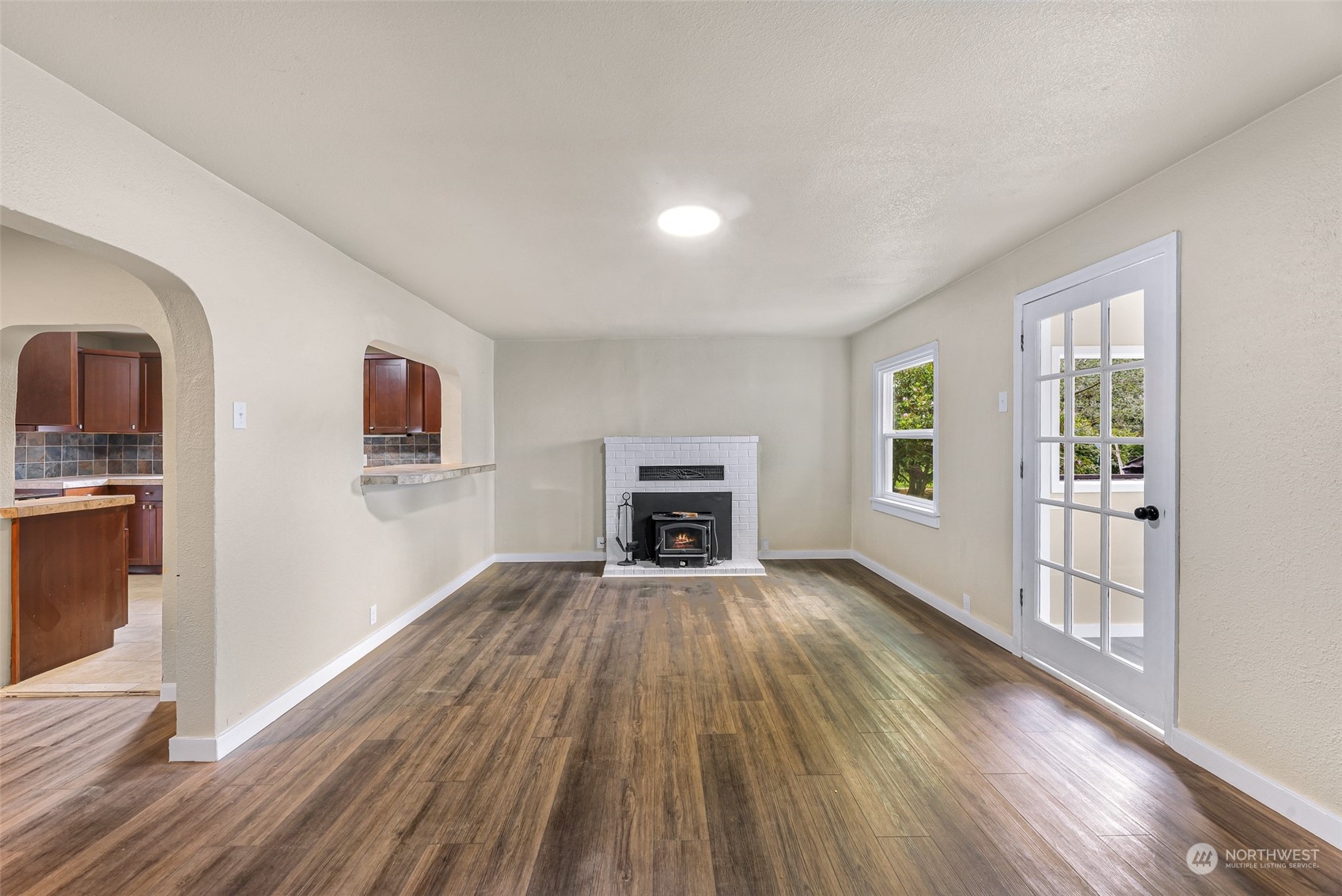 1102 Nevada Street Bellingham, WA 98229 - Photo 5 of 40 wooden floor in an empty room with a fireplace and a window