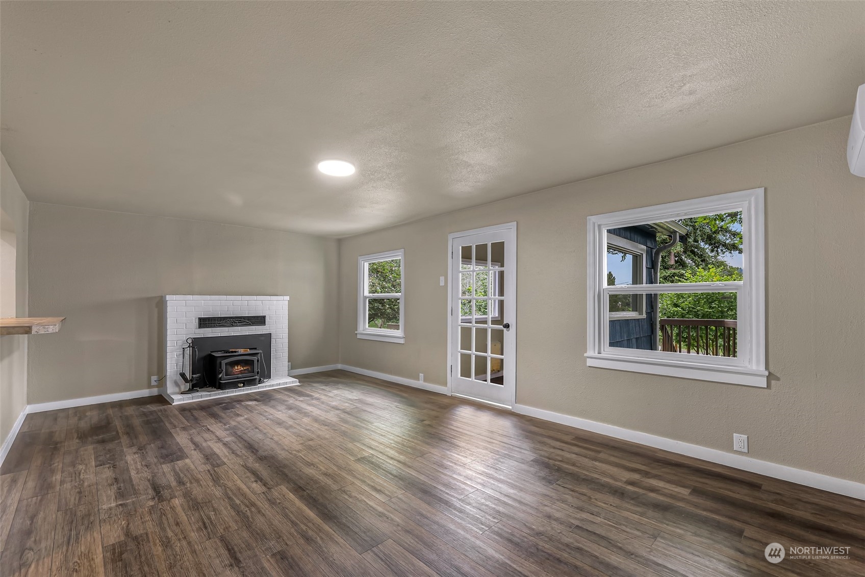 1102 Nevada Street Bellingham, WA 98229 - Photo 6 of 40 wooden floor fireplace and windows in an empty room
